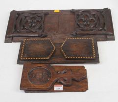 A 19th century carved pine bookslide in the Gothic taste, w.49cm; together with two oak examples Not