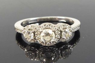 An 18ct white gold diamond triple cluster ring, featuring three graduated round brilliant cut