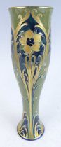 William Moorcroft for James MacIntyre & Co - a green and gold Florian ware Solifleur pottery vase,