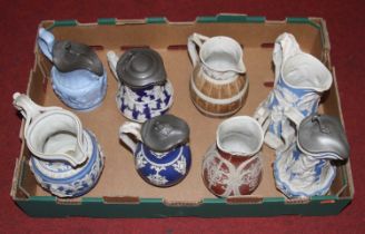 A collection of eight Victorian relief moulded jugs, to include Cobridge, the largest h.24cm