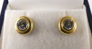 A pair of contemporary 18ct gold and diamond ear studs, each bezel set with a single round cut