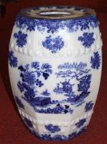 A blue and white pottery garden seat, decorated with flowers, h.48cm Large chip to handle on top.