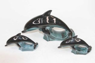 A collection of Poole Pottery models of dolphins, the largest h.18cm