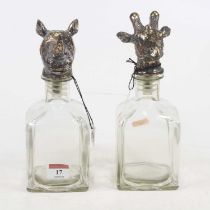 A pair of modern decanters, the stoppers in the form of a rhino and giraffe's head, 23cm