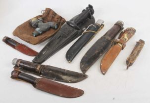 Assorted bowie and hunting knives in leather scabbards, etc