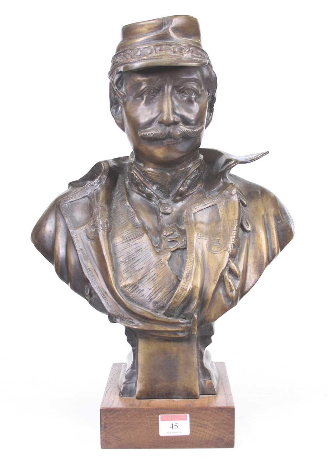 A bronzed metal head & shoulders bust of a French officer mounted to a rectangular wooden plinth,