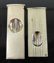 A modern engine turned white metal cigar cutter stamped 925, together with one other steel