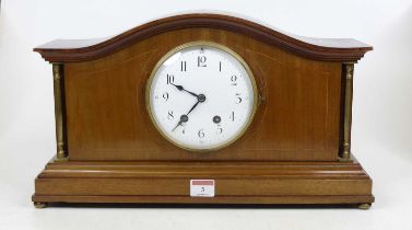 An Edwardian walnut cased mantel clock, the enamel dial with Arabic numerals and twin winding