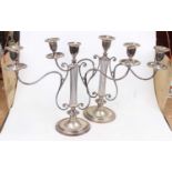 A pair of Edwardian silver plated three branch table candelabra having an oval sconce on knopped
