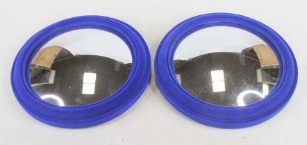 A pair of small convex wall mirrors in blue velvet frames, dia.23cm