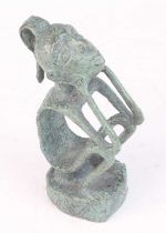 An ancestor figure, modelled in seated pose with head in hands and elbows on knees, mixed alloy,