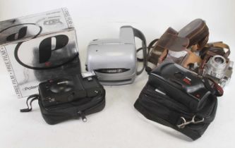 A Paxette 35mm camera together with various accessories, Polaroid camera etc