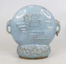 A Chinese blue glazed centre piece, relief decorated with a bird and flanked by mask handles,