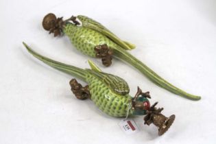 A pair of porcelain and gilt metal wall sconces, each in the form of a green parrot, h.48cm Brand