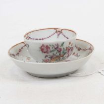 A late 18th century porcelain tea bowl and saucer, enamel decorated with a cornucopia of flowers,