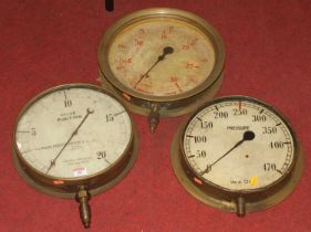 Three vintage brass pressure gauges, the largest dia.35.5cm