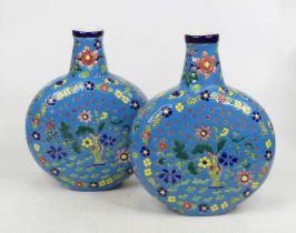 A pair of blue glazed moon flasks, each decorated with flowers, height 27cm