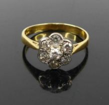An 18ct gold and diamond set flowerhead cluster ring, setting dia. 9.1mm, sponsor JB, 2.3g, size L