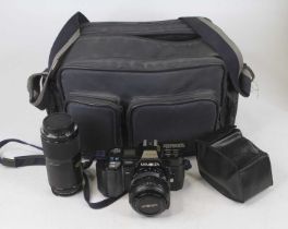 A Minolta 35mm SLR camera, with bag, and accessories Not currently working and may require a new