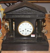 A Victorian black slate eight-day mantel clock, of architectural form, having an enamelled dial