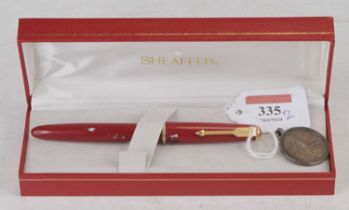 A Parker Junior fountain pen, having a 14ct gold nib, red cap and barrel with gilt clip and band, in