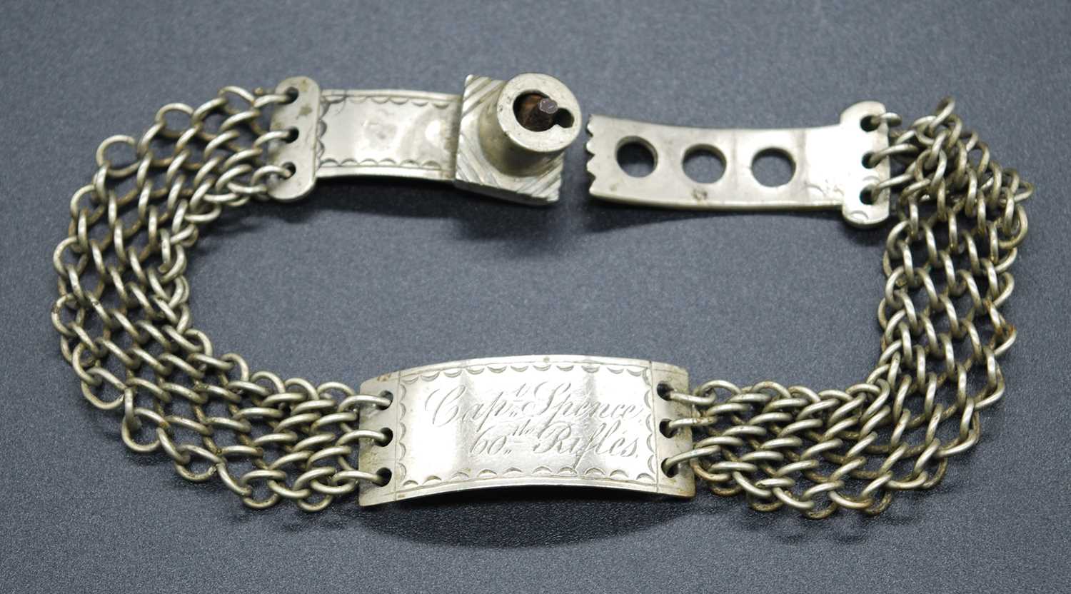 A 19th century identity bracelet, the central curved white metal disc engraved Capt. Spence 60th
