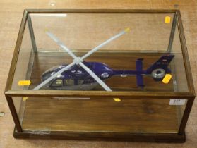 A cased scratch built model of a helicopter