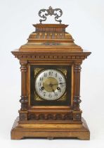 An early 20th century continental walnut cased eight-day mantel clock, the silvered chapter ring
