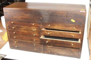 A 20th century hardwood table-top chest, having a hinged lid above twelve short drawers, w.60cm