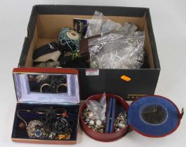 A shoebox containing assorted costume jewellery to include filigree and paste set brooches, beaded