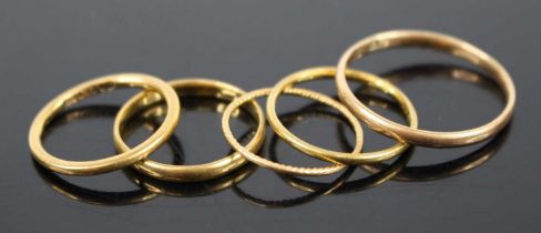 Five various gold wedding bands, all being lightweight examples, one marked for 22ct, some