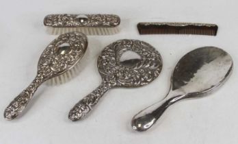 A Victorian style silver clad part dressing table set, comprising hairbrush and hand mirror, each