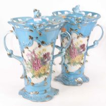 A pair of Sevres style vases, of twin handled trumpet shape, blue glazed and printed with flowers