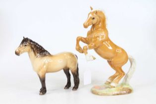 A Beswick model of a rearing horse, model No.1014, h.26cm; together with another Beswick model of