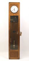 A Magneta oak cased electric Master clock, with one second pendulum, the movement operating on