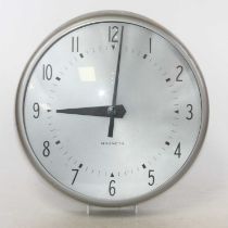 A Magneta metal cased wall clock, having signed silvered Arabic dial and Impulse 20volt movement,