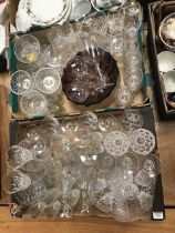 Two boxes of mixed glass ware to include an amethyst glass bowl, and drinking glasses