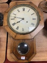 A late 19th century walnut cased droptrunk wall clock, having painted dial with Roman numeral