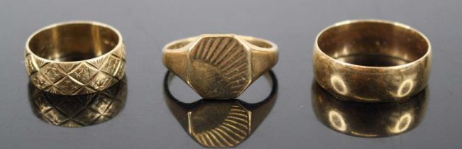 A 9ct gold signet ring; together with a plain 9ct gold wedding band; and an engraved example,