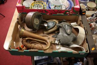 A collection of militaria to include a brass and copper bugle, gas mask, brass compass etc