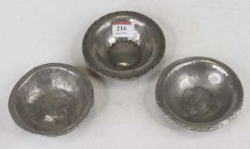 An Arts & Crafts hammer-beaten pewter dish, dia.11cm; together with two others, maker Hugh Wallace