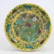 A Chinese yellow glazed dish, decorated with chrysanthemums, having apocryphal reign mark to the