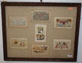 A framed collection of seven World War One silk postcards