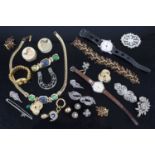 A bag of assorted costume jewellery, fashion watches, brooches etc