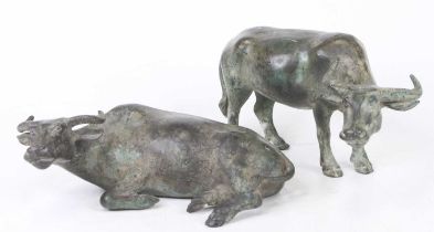 Two verdigris metal models of oxen, the largest length 26cm