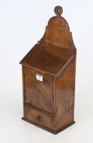 A 19th century fruitwood wall hanging salt and candle box, the shaped back above hinged