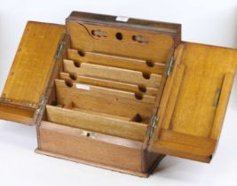 A Victorian light oak table-top stationery cabinet, the hinged doors opening to reveal fitted