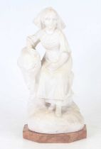 A carved marble figure of a seated girl, mounted upon a red polished hardstone octagonal plinth,