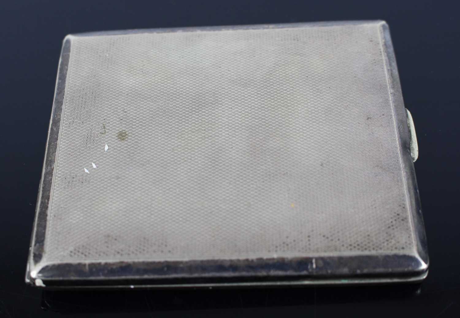 A white metal and engine turned pocket cigarette case, the hinged cover embossed with a pair of - Image 2 of 3