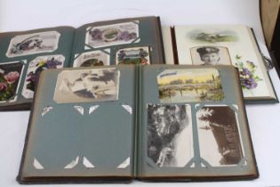 Three early 20th century postcards/photograph albums and contents